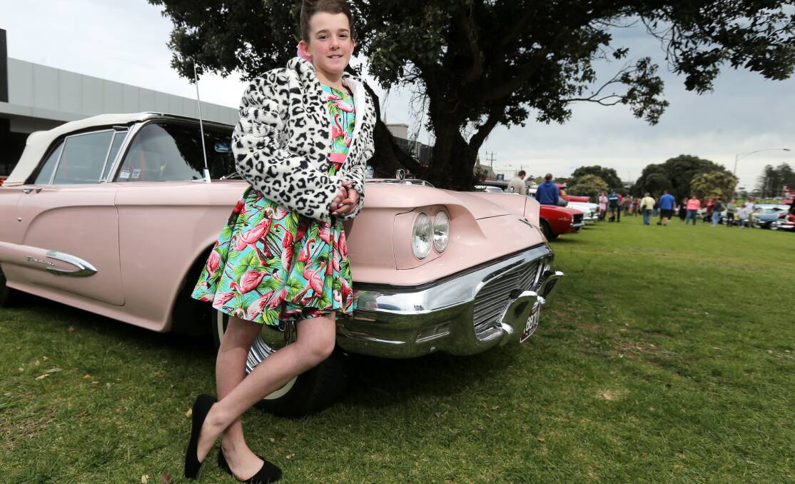 In the pink: Skye Kelly, 12 of Warrnambool, styled up in1950s fashion, pictured with a 1959 flamingo pink Ford Thunderbird. Picture: Rob Gunstone