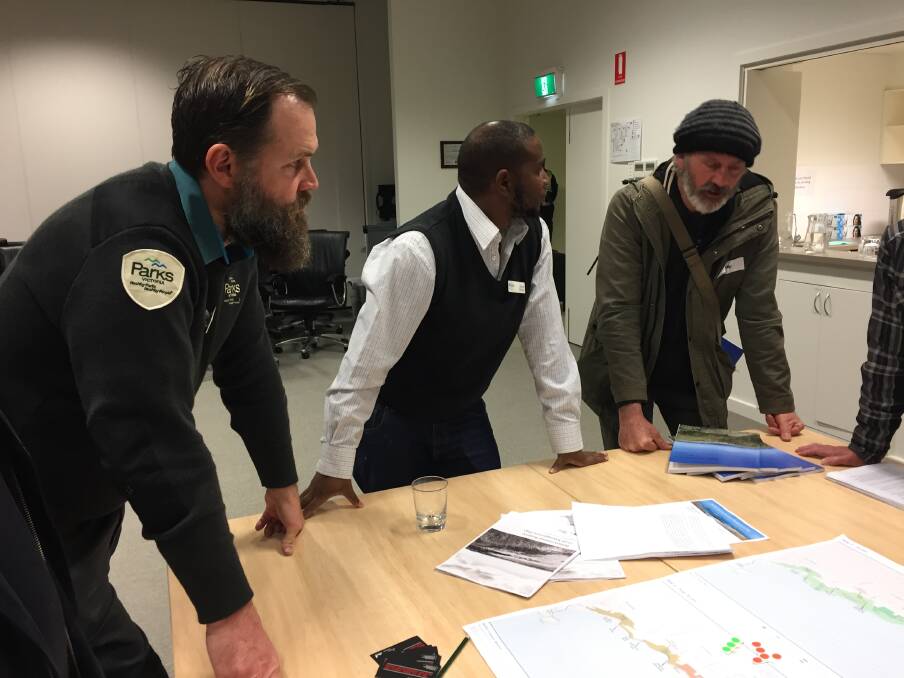 Questions: Parks Victoria staff members Ben Hammond and Joshua Chikuse address questions from concerned community members including Killarney's Shane Howard at Tuesday night's event. Picture: Rebecca Riddle.
