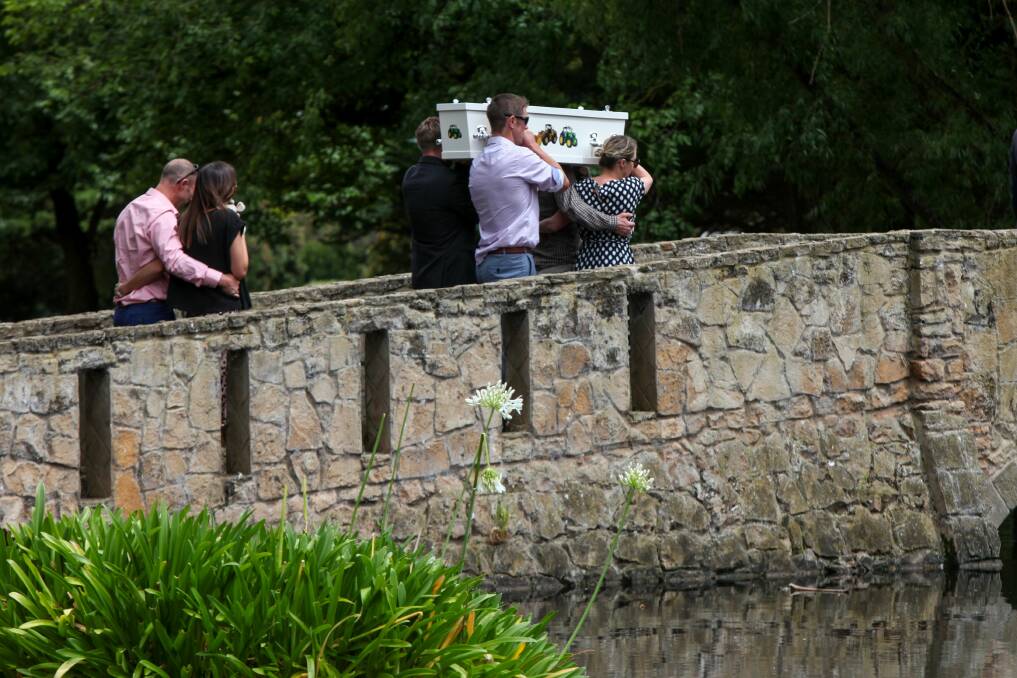 Darcy Membrey's parents, Travis and Sasha, follow the pall-bearers out of funeral service. Picture: Rob Gunstone