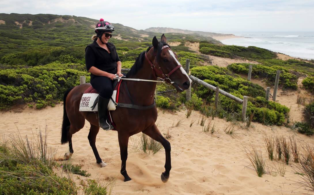 In training: Maddie Raymond exercises Melbourne Cup winner Prince Of Penzance in dunes at Levys Beach. Picture: Rob Gunstone