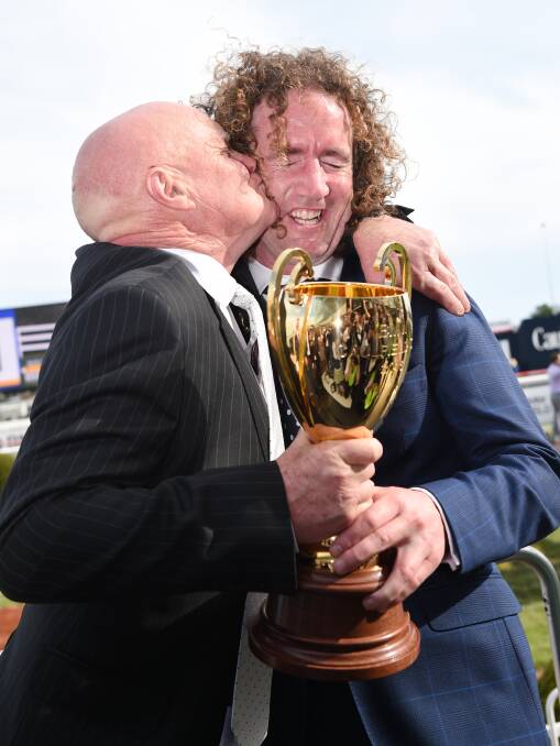 Part-owner Colin McKenna celebrates with trainer Ciaron Maher after Jameka's Caulfield Cup triumph. Picture: Getty