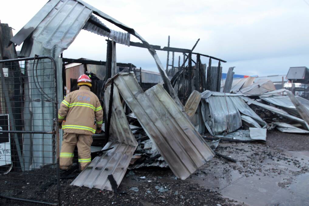 Damage: A firefighter inspects the damage late on Thursday. Picture: Everard Himmelreich
