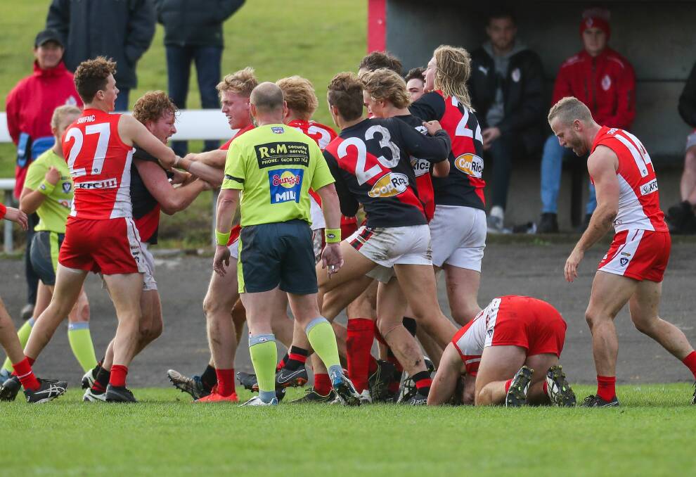 Flash point: South Warrnambool players remonstrate with Cobden's Paul Pekin while (right) an injured Liam Youl is hunched over on the ground. Picture: Morgan Hancock