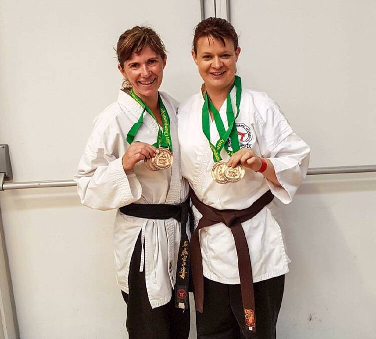 New Bling: Warrnambool Funakoshi Karate students Jill Cole and Kathryn Milroy show off their medals.