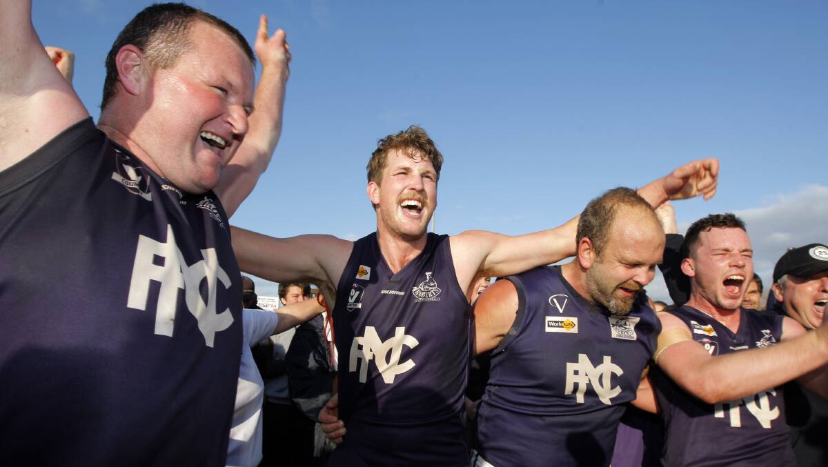 PREMIERS: Luke Parsons (left) celebrates with Bronte McCann and Gary Robinson after the Blues' 2016 premiership victory. 