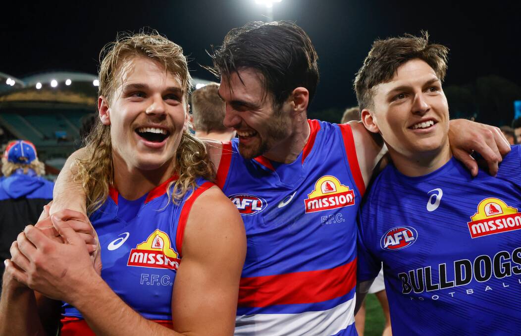 GOOD VIBES: Easton Wood (middle) celebrates the win with Bailey Smith (left) and Laitham Vandermeer. Picture: Getty Images