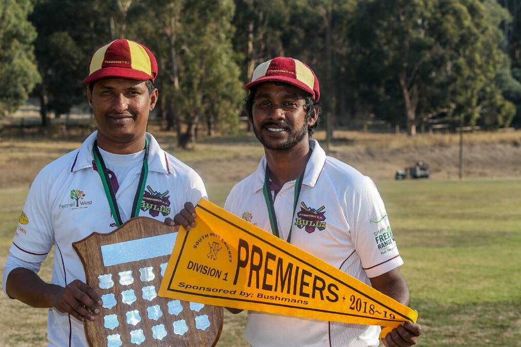 FRIENDS: Pomborneit's Sri Lankan stars Tharaka Sendanayake and Lahiru Fernando with the shield and flag after the South West Cricket Association grand final. Picture: Anthony Brady