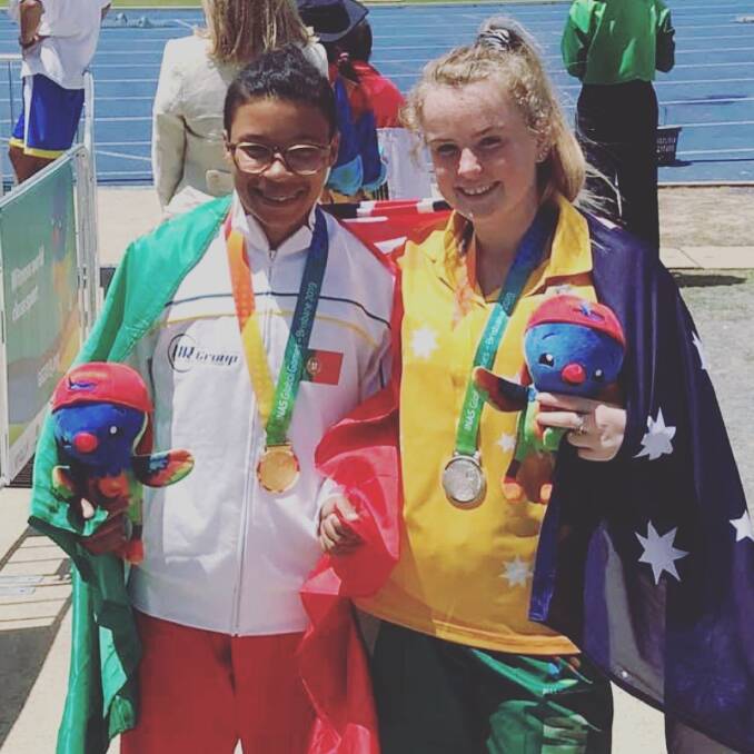 WINNER'S SMILE: Terang's Caytlyn Sharp poses for a photo with Portugal's Ana Filipe after they collected gold and silver in high jump on Thursday.