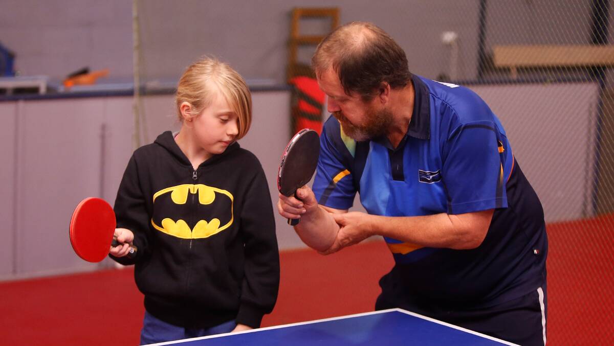 TIPS: Allansford's Brianna Woodbridge gets some advice from Warrnambool Table Tennis Association player and president Mark Taylor.