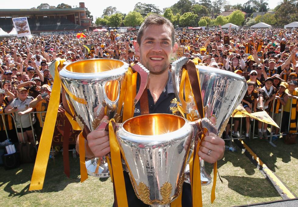 THREE'S A TREAT: Luke Hodge shows off his third premiership as Hawthorn's skipper after the 2015 grand final. Picture: Getty Images