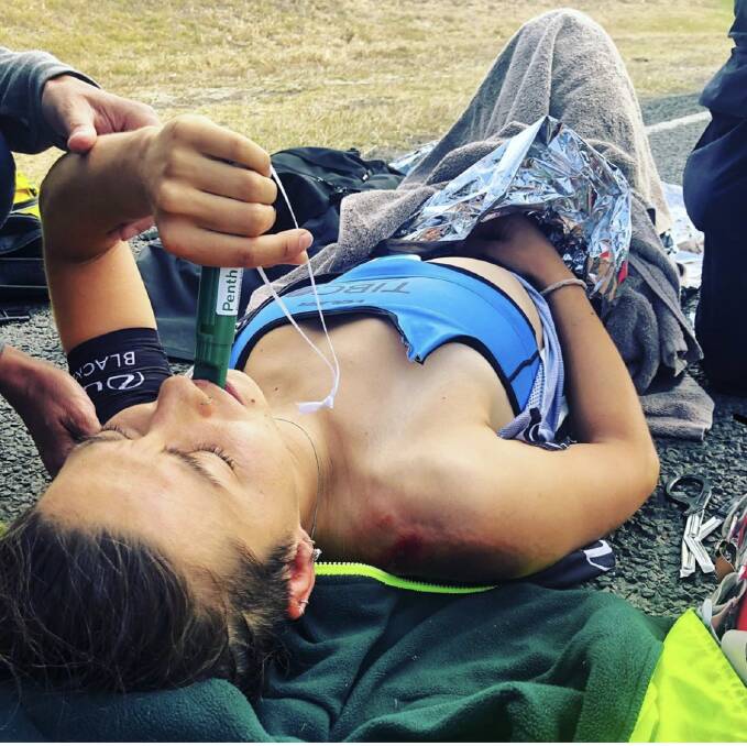 PAIN: Malseed lies by the side of the road with a green whistle after her most recent injury in January. Picture: Shannon Malseed/Instagram