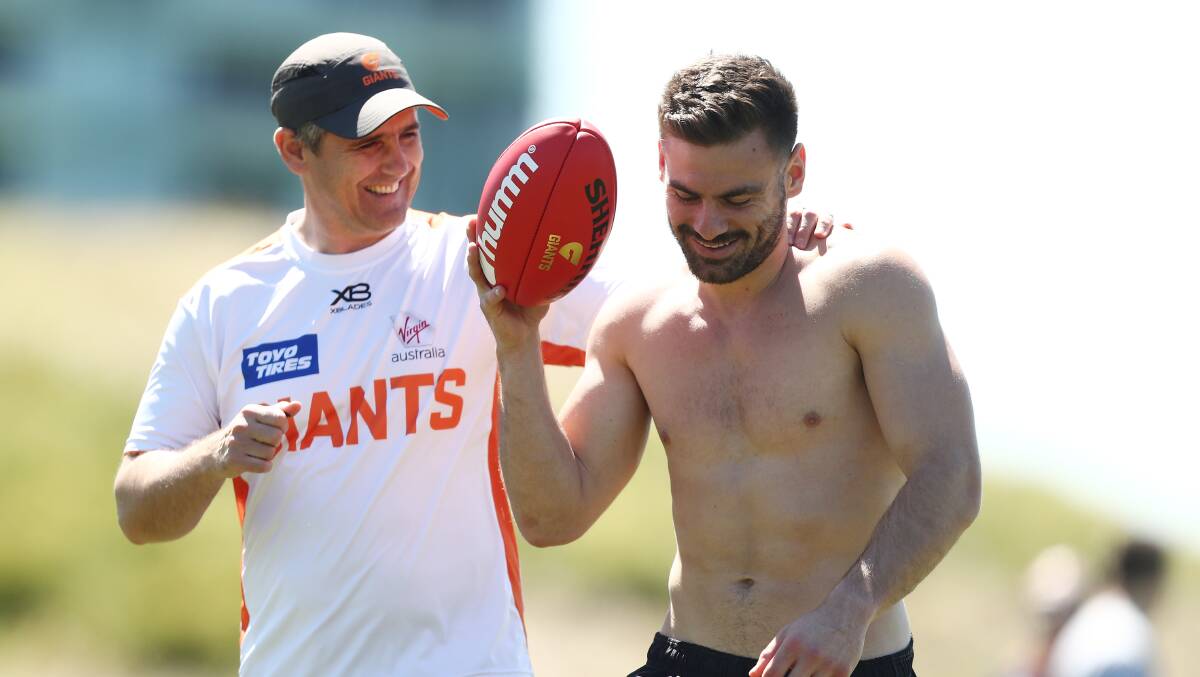 CLOSE BONDS: Leon Cameron is close with a number of his players. Here he shares a laugh with captain Stephen Coniglio during pre-season. Picture: Getty Images