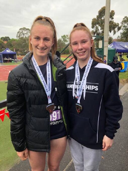 NEW BLING: Layla Watson and Grace Kelly show off their victorian All School medals.