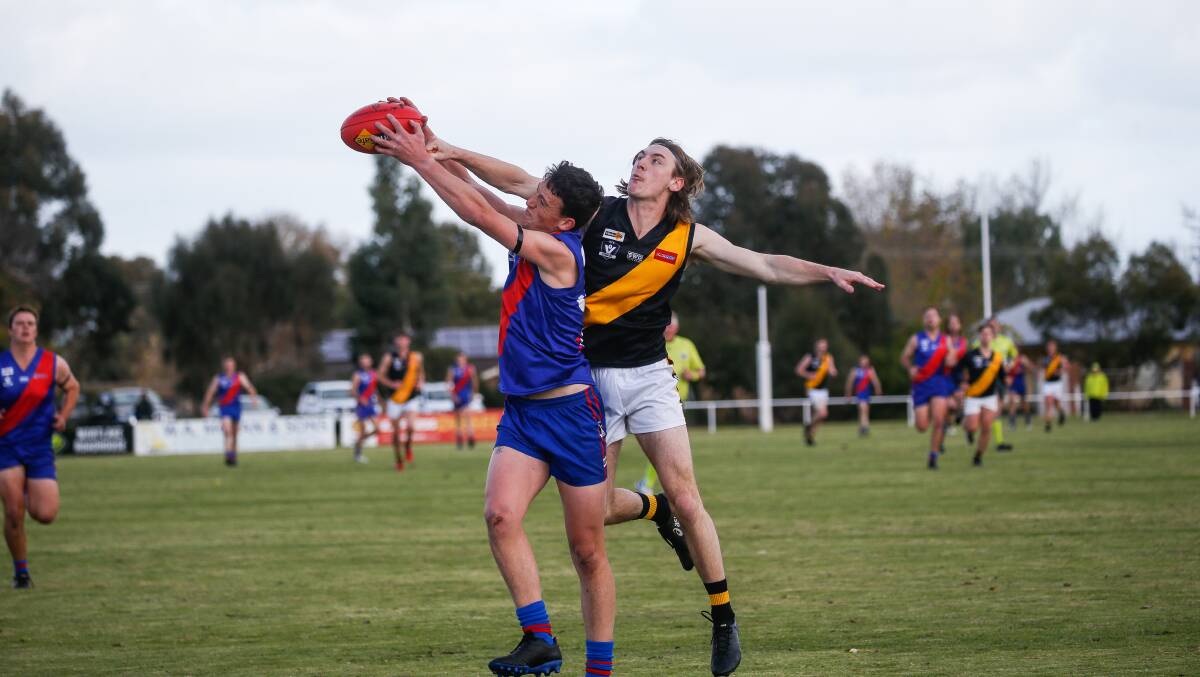 GOOD HANDS: Terang Mortlake's William Kain takes a strong mark in front of Portland's Harrison Hampshire. Picture: Anthony Brady