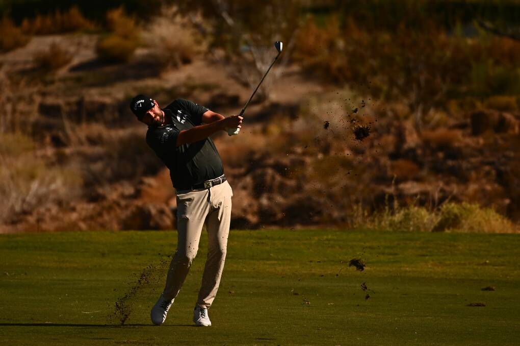 HITTING THE GREEN: Marc Leishman follows through after hitting his shot towards the 18th green. Picture: Getty Images