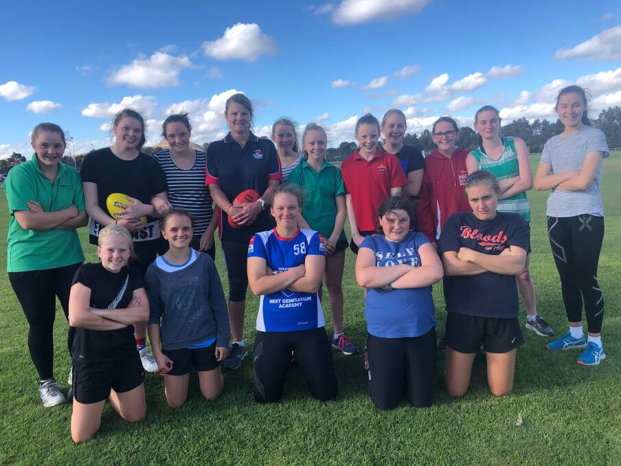 TEAMING UP: New Terang Mortlake coach Tania Barbary (fourth from the left at back) poses with her team after their first training session on Wednesday night.