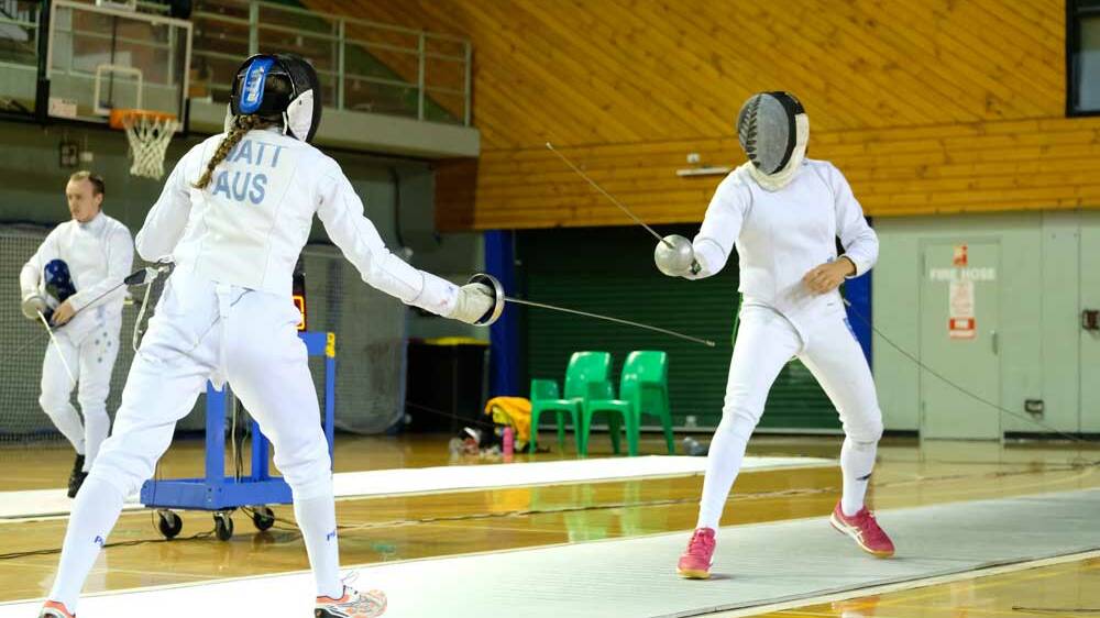 QUICK FEET: Tully Watt (left) prepares to strike at her opponent in the fencing stage of the titles. Picture: William Taylor