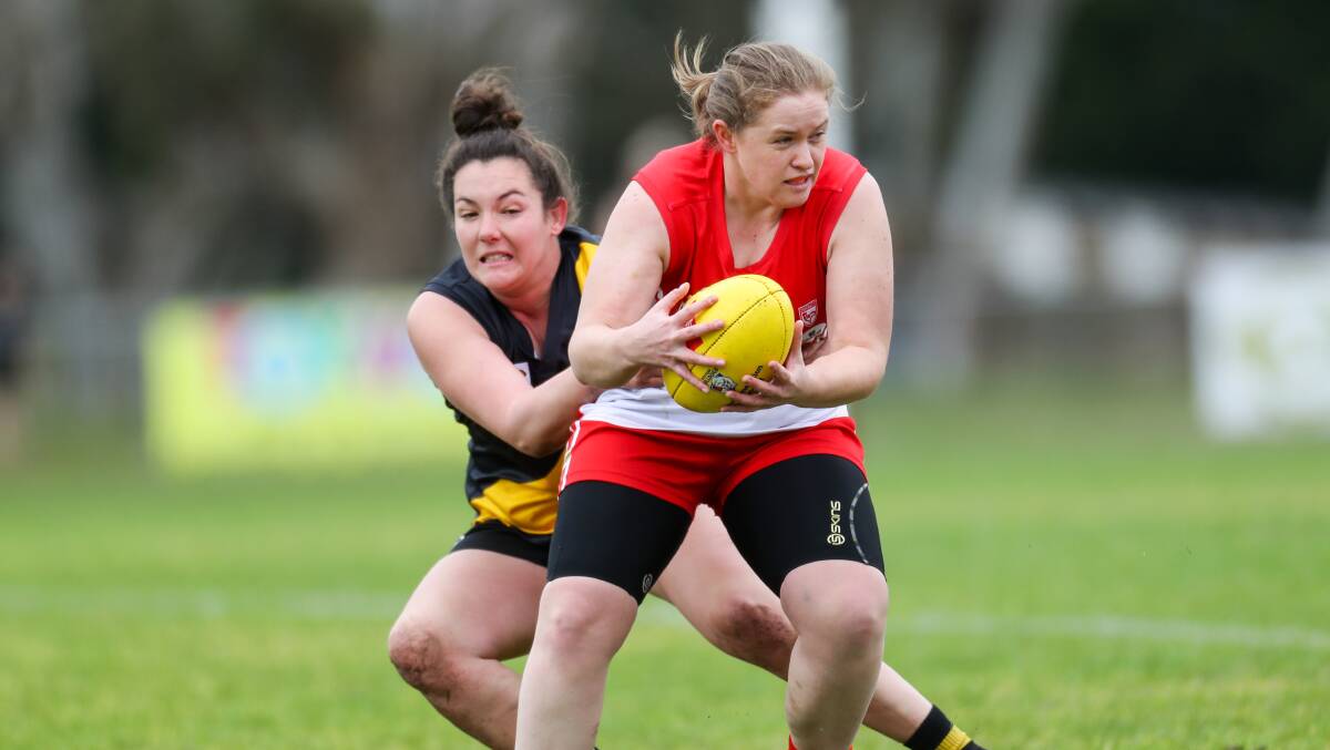 KEEPING HER FEET: South Warrnambool's Hannah Meates looks for dish off a handball during the 2019 senior women's grand final. Picture: Morgan Hancock