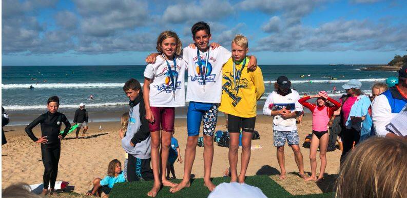 Jack McNeil stands on top of the podium after winning the under 12 beach sprint. Will Main (left) was close behind in second.