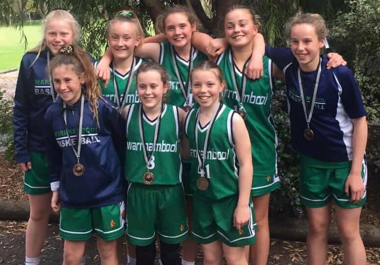 CHAMPIONS: Warrnambool Mermaids under 14 side celebrate after they won the division one at the Millicent Junior Basketball Tournament on Sunday. 