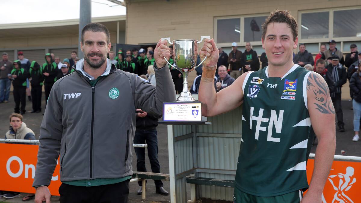 DYNAMIC DUO: Hampden league coach Chris McLaren and captain Sam Cowling show off the spoils of victory in 2015.