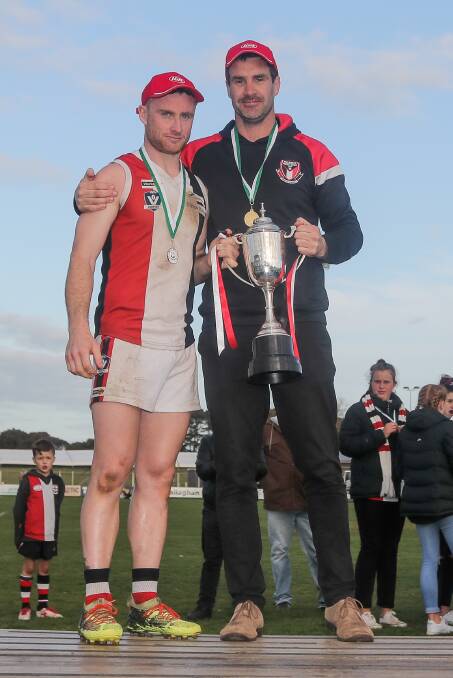 SUCCESS?: Koroit captain Brett Harrington and senior coach Chris McLaren show off the club's fifth consecutive premiership cup. McLaren says the start time of pre-season training is based on a number of factors. Picture: Morgan Hancock