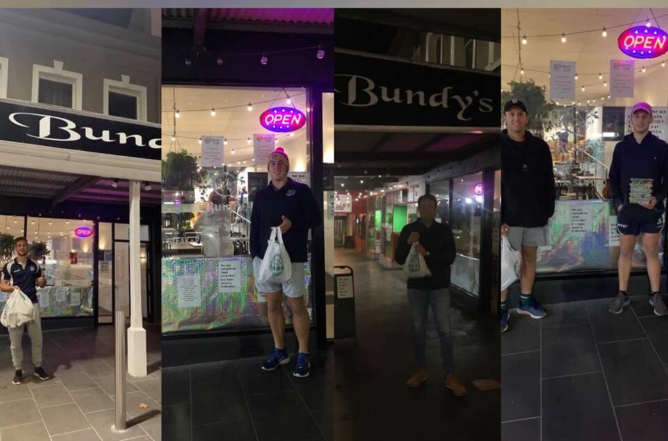 SUPPORTING: Warrnambool players pose out the front of Bundy's - the place nominated for the Blues Business Boost this week. Picture: WFNC Facebook