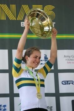 GOLD: Grace Brown lifts her trophy atop the podium. Picture: Con Chronis