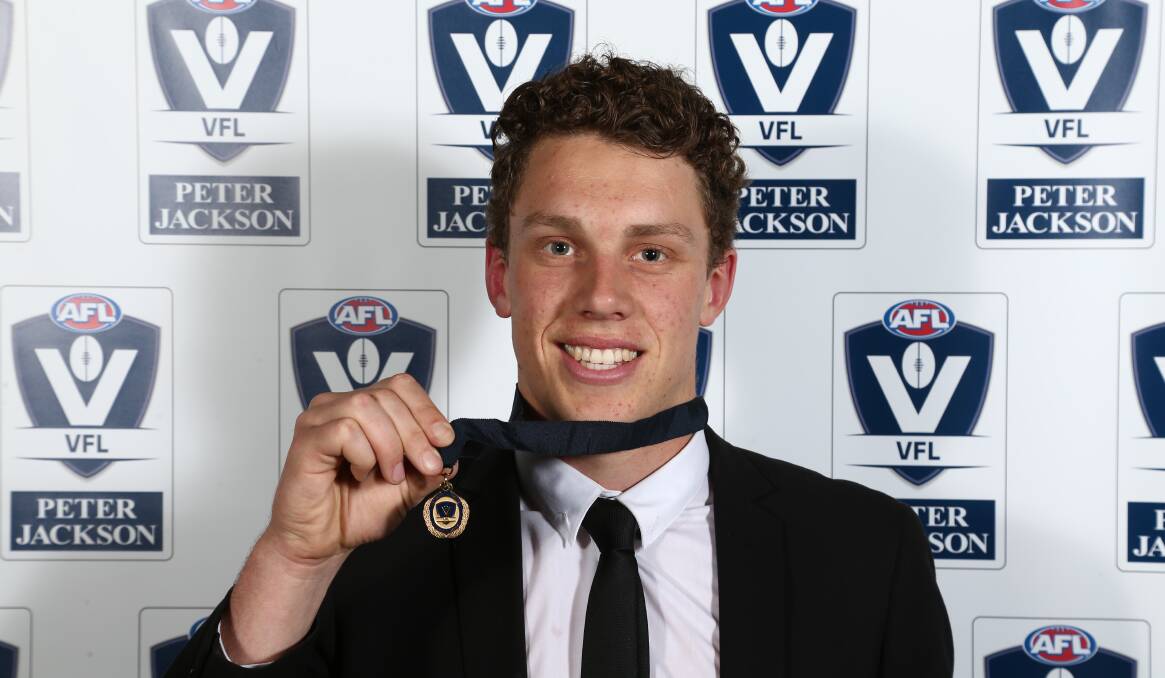 FLYING HIGH: North Warrnambool Eagles export Josh Corbett shows off his Fothergill-Round-Mitchell Medal on Monday night.