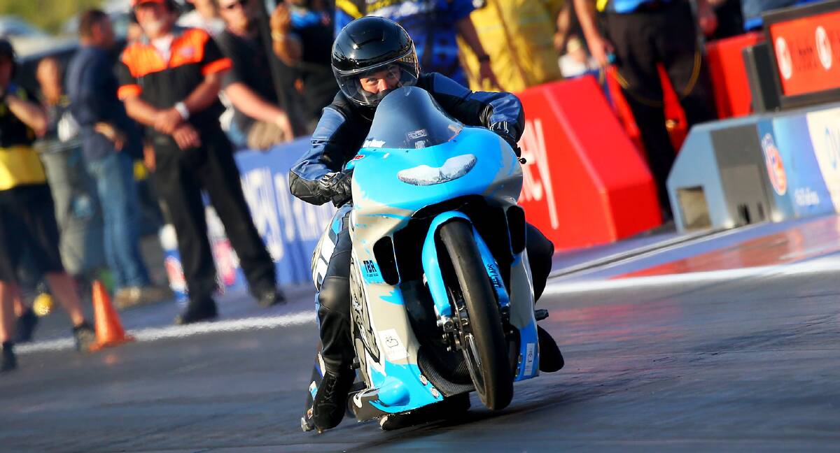 FOCUSED: Glenn Wooster gets low at the start of his Pro-stock bike run. Picture: Cackling Pipes