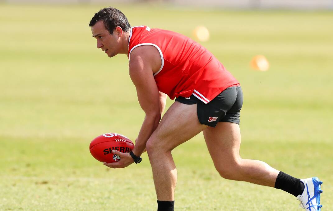 BACK INTO IT: Lewy Taylor gets a handball away during a Sydney training session on Monday. The 24-year-old is eagar to make an impact at the Swans. Picture: Sydney Swans