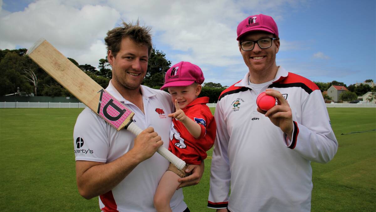 TEAM EFFORT: Dennington's Jonny Malone, with his son Reggie, 2, and Koroit's Matt Webster ahead of the first week of the Saints' Pink Stumps game this Saturday. Picture: Sean Hardeman