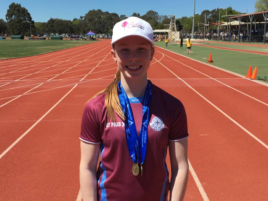 NEW BLING: Grace Kelly shows off medals she won at a regional school athletics carnival.