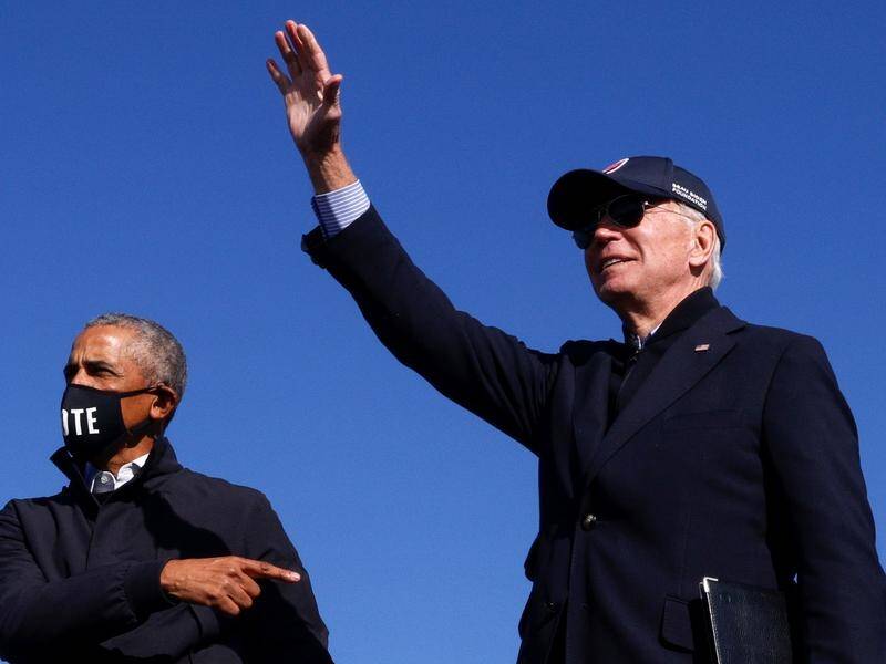 Barack Obama (left) and Joe Biden at the rally where the former President slated Donald Trump.