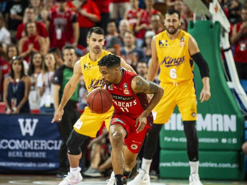 Bryce Cotton (C) has proved the difference in the Wildcats' overtime NBL win over Sydney in Perth.