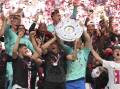 Jubilant Bayern Munich players celebrate winning the title after beating Cologne on Saturday. (AP PHOTO)
