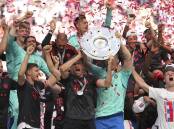 Jubilant Bayern Munich players celebrate winning the title after beating Cologne on Saturday. (AP PHOTO)