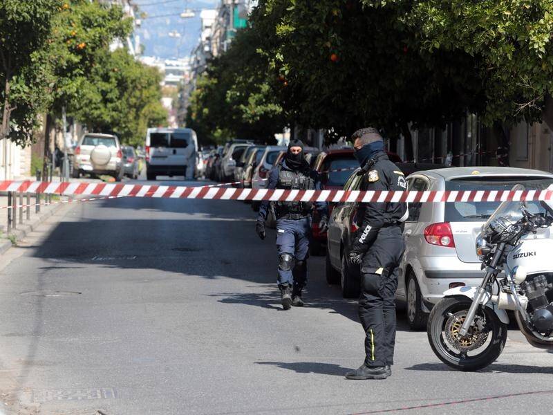 Greek anti-terrorism officers say they have seized heavy weapons after raids in Athens.