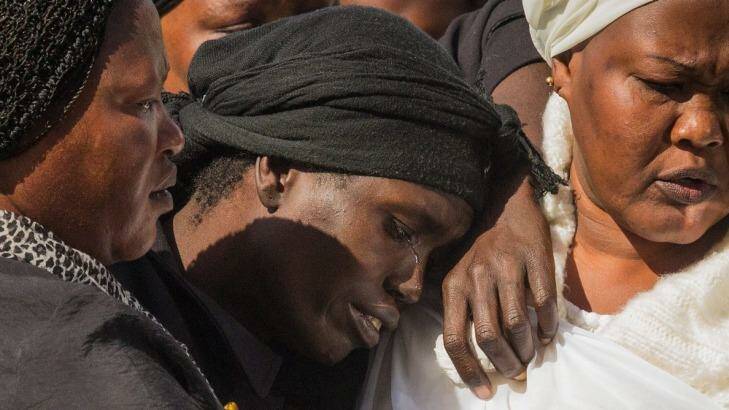 Akon Guode at the funeral for her three children in 2015. Photo: Chris Hopkins