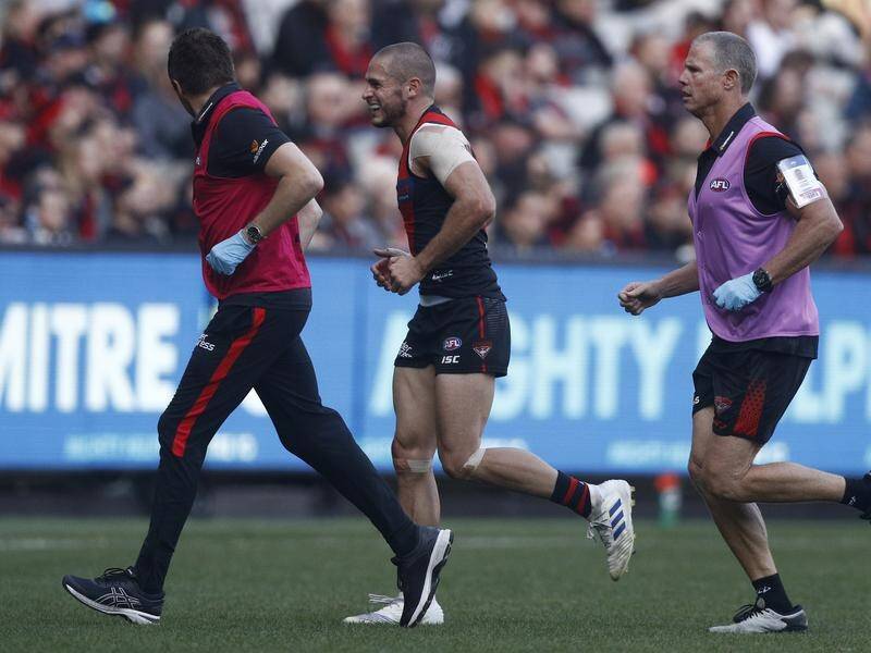 David Zaharakis (C) and Devon Smith are set for Essendon's Anzac Day AFL classic with Collongwood.