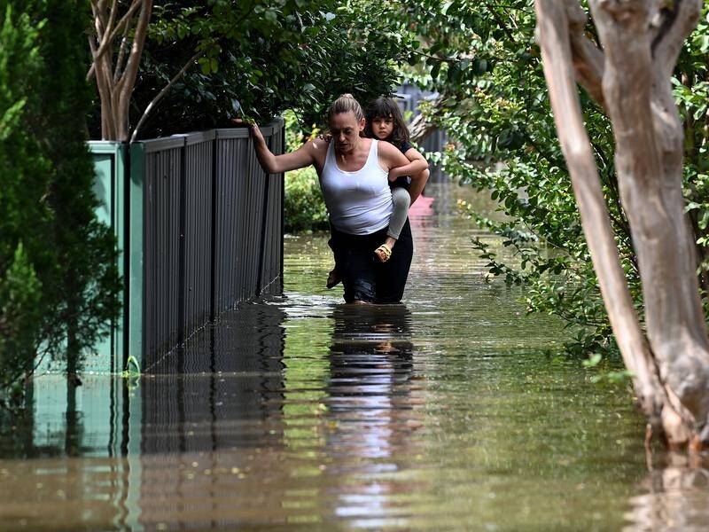 Residents walk through floodwater in Windsor, where the Hawkesbury River reached 14 metres.