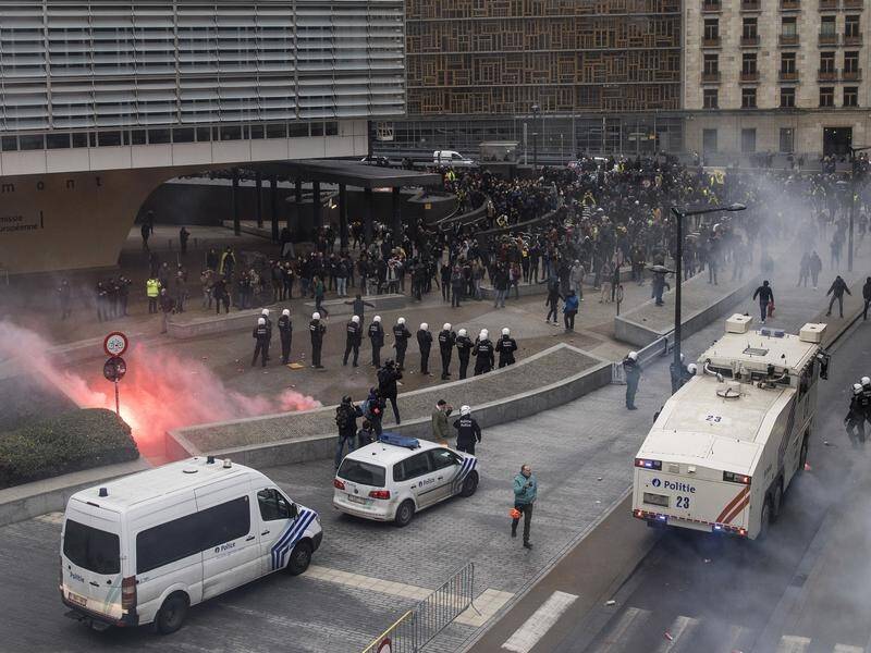 Belgian police have used tear gas and water cannon to disperse protesters in Brussels.