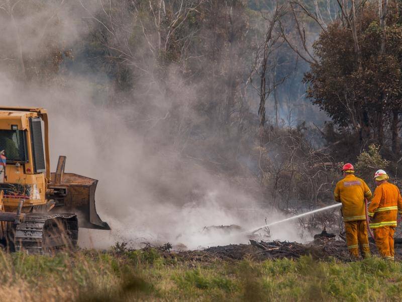 Firefighters are battling a bushfire in Tasmania's southwest as a cold front holds hope of relief.