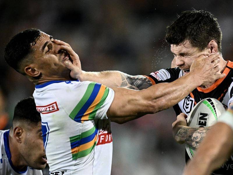 Raider Jamal Fogarty (left) felt sorry for the Wests Tigers after his game-winning penalty goal. (Dan Himbrechts/AAP PHOTOS)