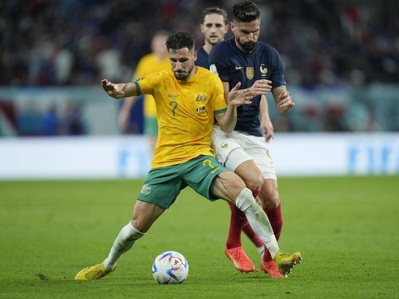 Mathew Leckie (l, holding off Olivier Giroud) wants to inspire the next generation of Socceroos. (AP PHOTO)