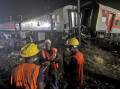 Rescuers are searching the mangled wreckage of trains that collided in India to find survivors. (AP PHOTO)