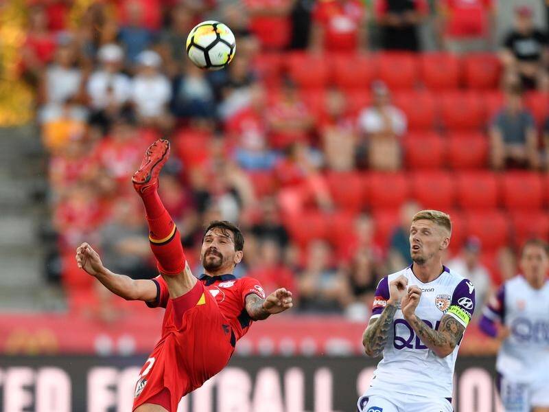 Ersan Gulum of Adelaide United and Andrew Keogh of Perth Glory contest the ball in the A-League.