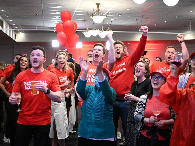 Excited Labor supporters react party reception in Melbourne as the results came through. (James Ross/AAP PHOTOS)