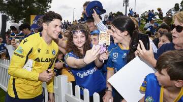 Mitch Moses, seen with Eels fans on Monday, hopes to follow fatherhood with a premiership this week. (Brett Hemmings/AAP PHOTOS)