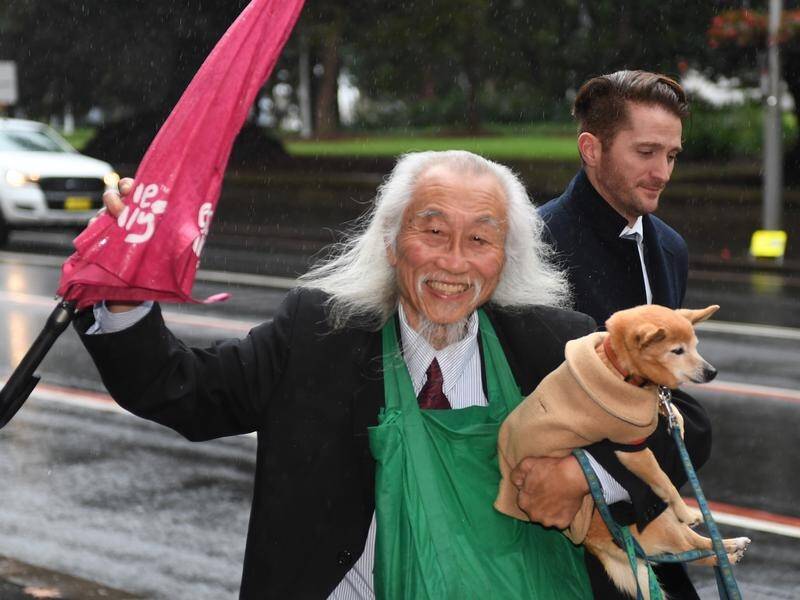"We need Australia to smile again," says sandwich board man Danny Lim.